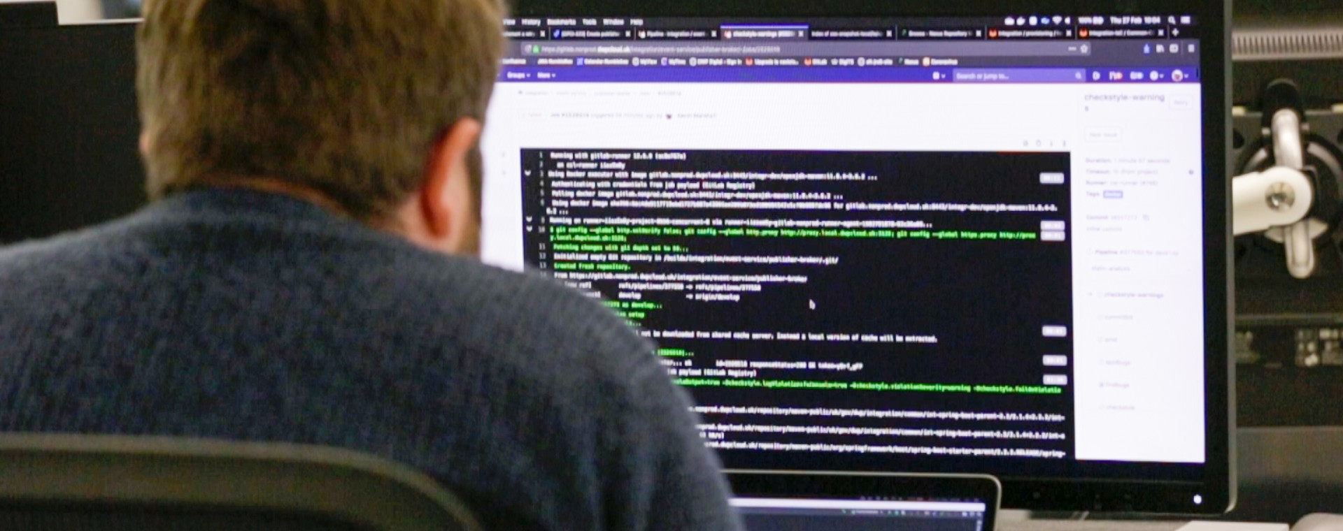 Image of a man coding on a desktop computer